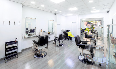 Modern bright hair and beauty salon. Barber salon interior business with black and white luxury decor. - obrazy, fototapety, plakaty