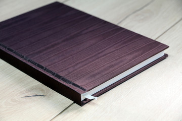 notebook on wooden  table with pen and coffee