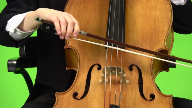 Cello close up bow touches the strings. Green screen