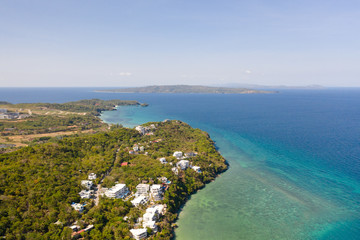 Boracay island, view from above. Rocky coast with rainforest. Seascape with green island.