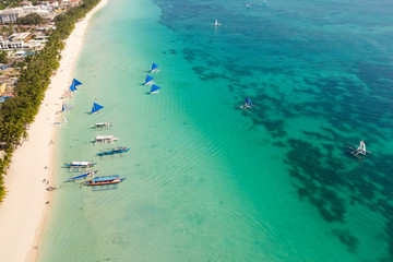 Beautiful lagoon with boats and tourist beach. White beach on the island of Boracay, top view....