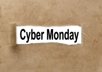 Obraz premium Text Cyber Monday appearing behind ripped brown paper.