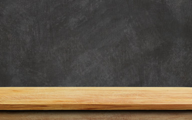 Empty wood table top on chalkboard background.