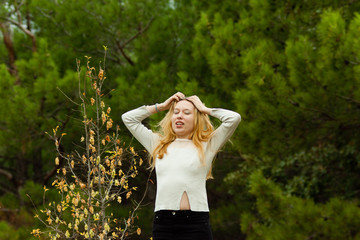 beautiful girl stands on stone wall