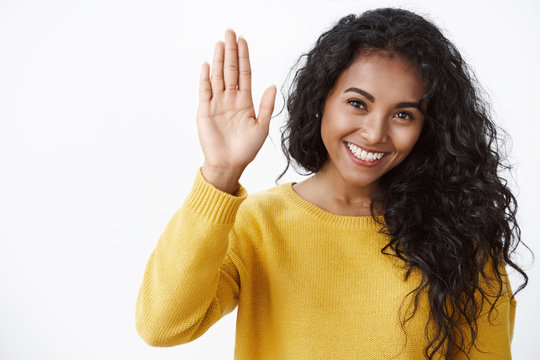 Girl giving high five, happy with productive team work. Cheerful curly-haired african american woman raise hand to congratulate friend with job well done, smiling supportive, white background