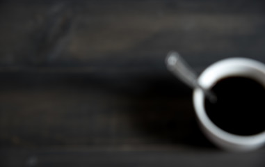 Blur photo of Cup of Coffee on wooden background