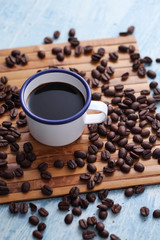 Coffee in cup and coffee bean on rustic table with a blank space for a text, Espresso in cup on blue background