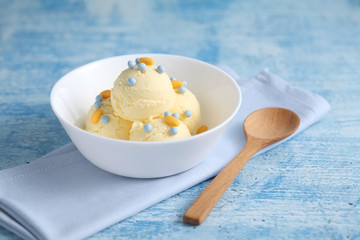 vanilla ice cream and candy on a blue background with a blank space for a text, vanilla ice cream in white ceramic cup