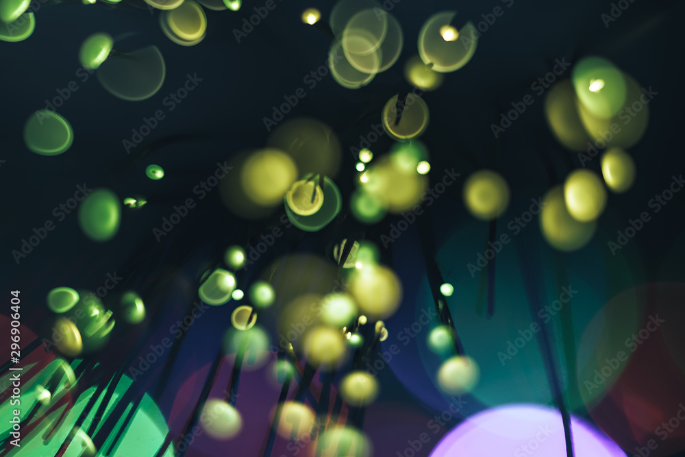 Poster beautiful abstract fiber optical network cable on a multi colored glow background.