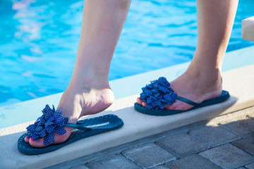 Beautiful female foot in swimming pool