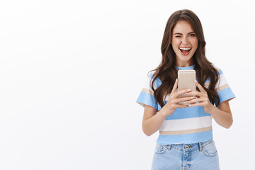 Cheeky stylish modern woman taking selfie in mirror, winking herself ambitious and flirty show...