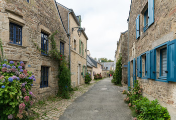 older couple walks through the narrow streets of an idyllic French village