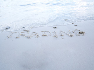 The letters trading were written on the sand with natural beauty