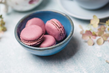 pink macaroons on a blue plate