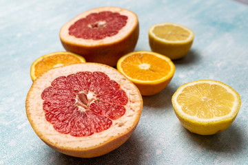 bright slices of oranges and grapefruit on a blue background