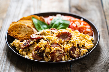 Breakfast - scrambled eggs with sausage and toasts