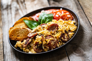 Breakfast - scrambled eggs with sausage and toasts