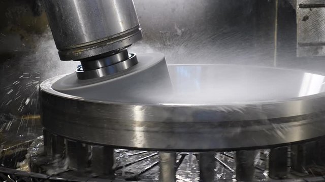Equipment at bearing factory. machine tooling unit ready for polishing workpiece surface. Heavy industry concept. Water jets cooling parts during production process. 4k
