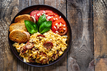 Breakfast - scrambled eggs with sausage and toasts