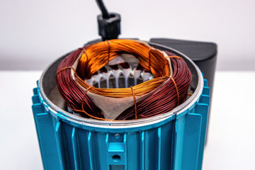 Open housing of the surface centrifugal pump. Blue motor case. Copper and aluminum winding.