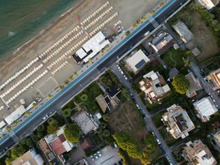 Fototapeta premium Top view of a coastal town with a beach and beach umbrellas. Terracina, Province of Latina, Lazio Region, Italy
