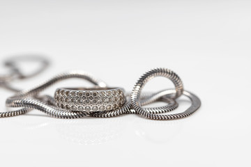 Delicate silver diamond ring and silver chain with elegant design