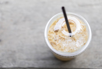 Closeup ice coffee on wood table with nature background
