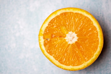 a bright slice of orange on a blue background