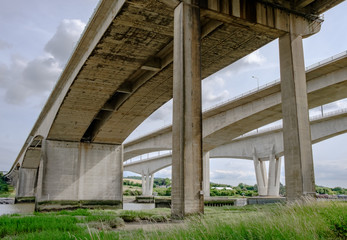 Close-up, structural view of the impressive architecture and construction of a major motorway, spanning a River in the United Kingdom.