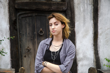 Fototapeta na wymiar Young Woman in Front of Old Door
