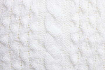 White knitted sweater texture as background. Knitted pattern. Top view. Macro view