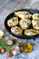 Selective focus. Baked pears with dorblu cheese and herbs.
