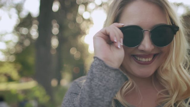 Pretty Blonde Girl Laugh Sunglasses Image Closeup. Young Caucasian Lady Smile Express Face Powerful Emotions Fool Around. Joyful Female Adult Enjoy Happy Moments Happiness Concept Slow Motion 4K