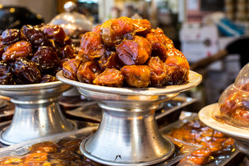 Close Up Of Pile Of Dried Date Fruits In A Silver Metal Plate With Stand Exhibiting In The Shop during ramadan