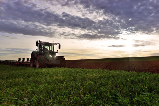 farmer plowing his fields at dusk