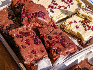Delicious home baked brown and white chocolate bars with pomegranate seeds close up shot at the local fair.