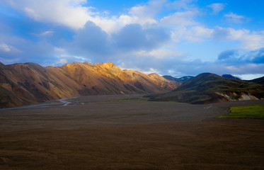 Iceland in september 2019. Great Valley Park Landmannalaugar, surrounded by mountains of rhyolite and unmelted snow. In the valley built large camp. The concept of world tours.