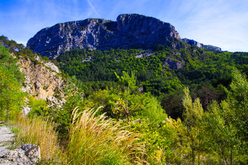 View over green valley on mountain peak against blue sky - Gorges du Verdon, Provence, France