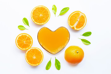 Heart shape glass of fresh orange juice with orange fruit on white background. Top view