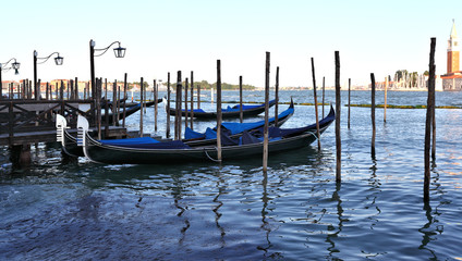 Fototapeta na wymiar Gondolas rest at their moorings, Venice - Italy