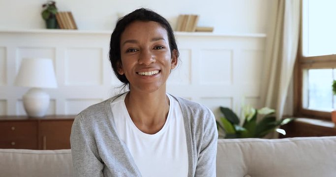 Happy african woman talking to webcam make videocall at home