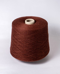 bobbin of yarn on a white background. Side view.Textile reel on isolated white background.