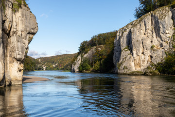 Fototapeta na wymiar Danube river breakthrough near Kelheim, Bavaria, Germany in autumn with limestone rock formations and clear water on a sunny day at autumn month october