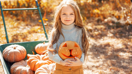 Young adult mother and daughter looking at carved pumpkin with smoke
