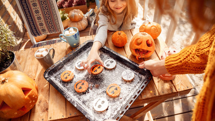 Young adult mother holding cookies biscuit on tray pan