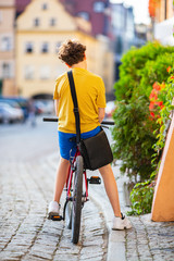 Young boy biking in city