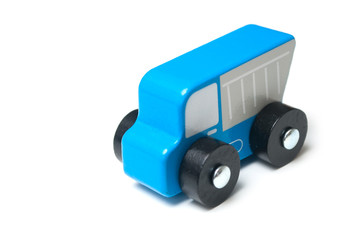 Closeup of miniature toy, wooden blue truck on white background