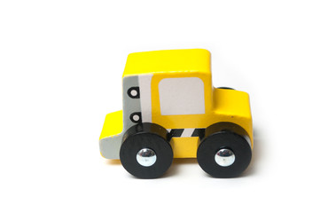 Closeup of miniature toy, wooden yellow car on white background