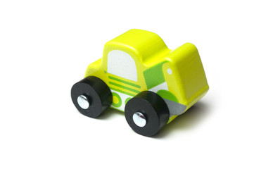 Closeup of miniature toy, wooden green car on white background