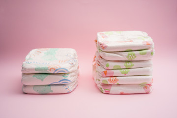Baby diapers with liquid absorbance on pink background